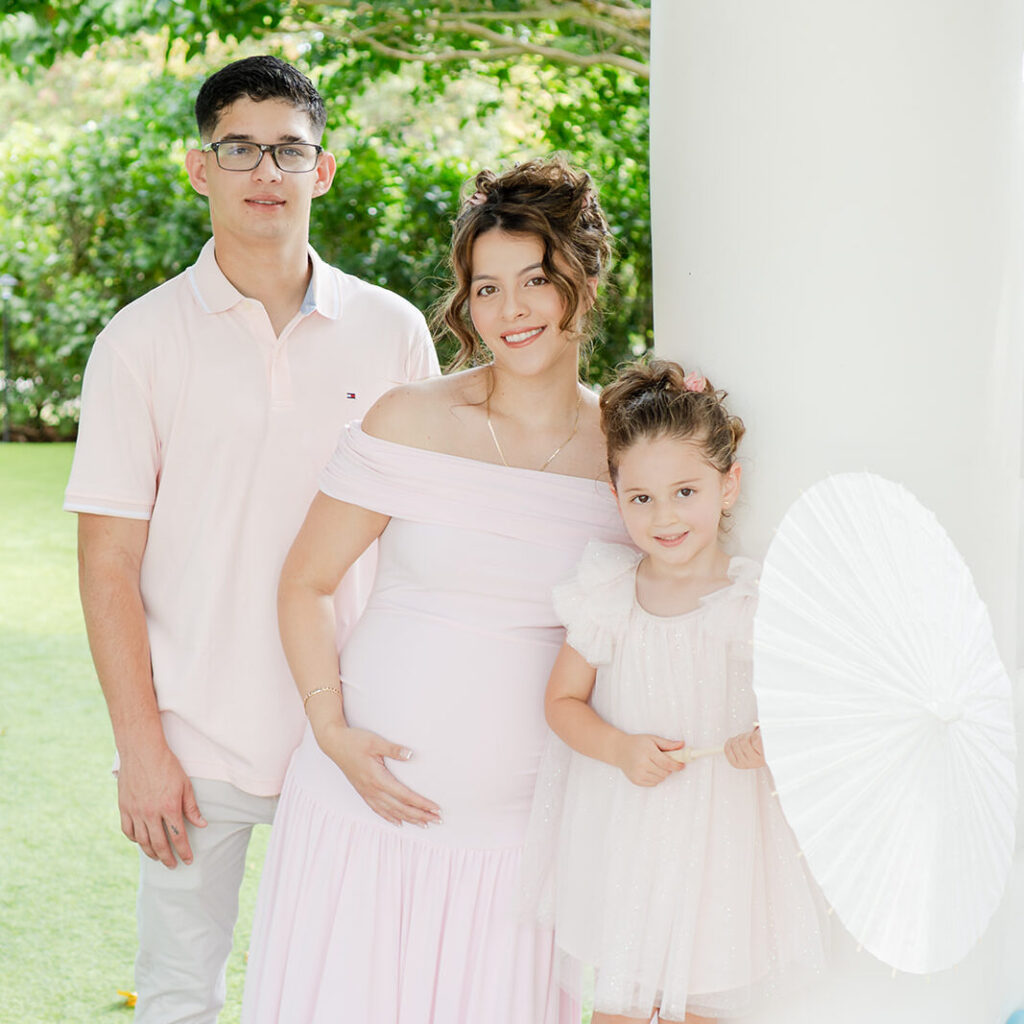 Parents-to-be wearing coordinated blush outfits at their Garden Rose baby shower.